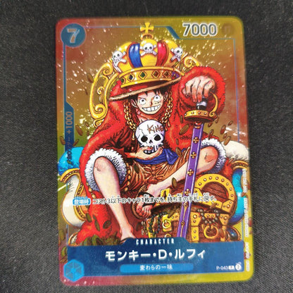 One Piece Monkey D. Luffy P-043 collectible card showing front with minor scratches and paint peeling on back