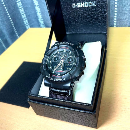 Used Casio G-Shock 5081 GA-100MC watch with visible scratches and peeling paint on belt joint