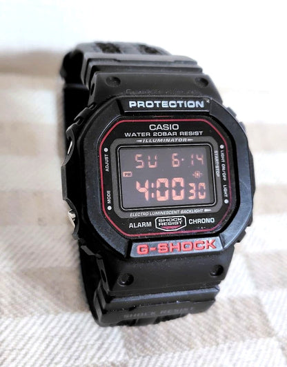 Casio G-Shock Square DW-5600 digital watch with black bezel and band, clear display, 20 ATM water resistance