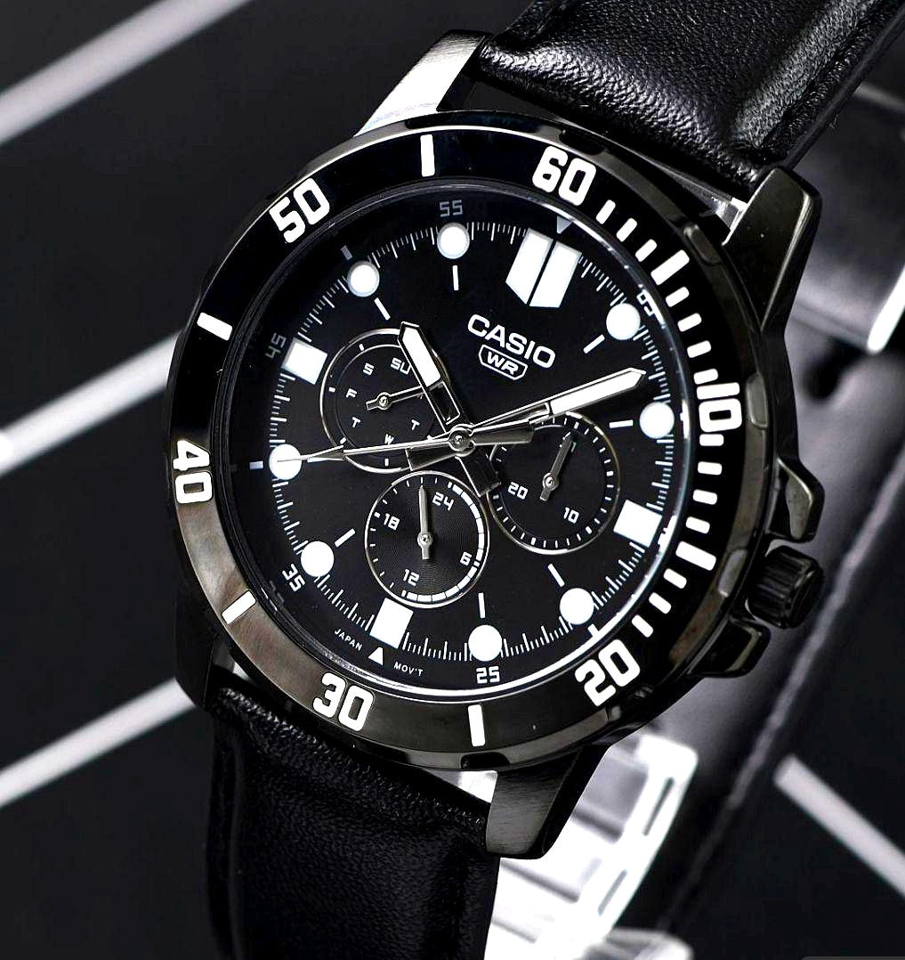 Casio import black metallic multi-function watch with leather band showing date and day calendar