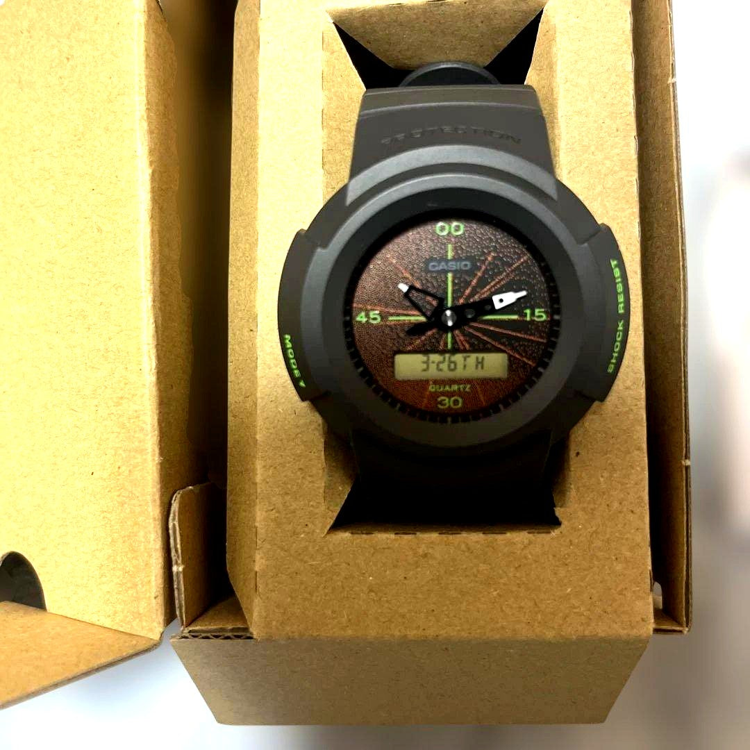 Casio G-Shock AW-500MNT-1AJR watch with dark gray face and orange accents on black strap