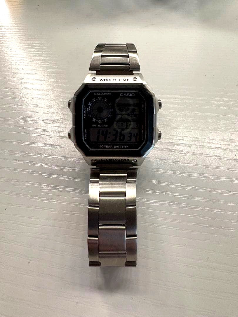 Casio digital watch with silver stainless steel band and world time display