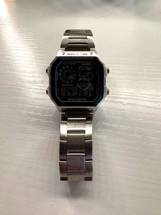 Casio digital watch with silver stainless steel band and world time display