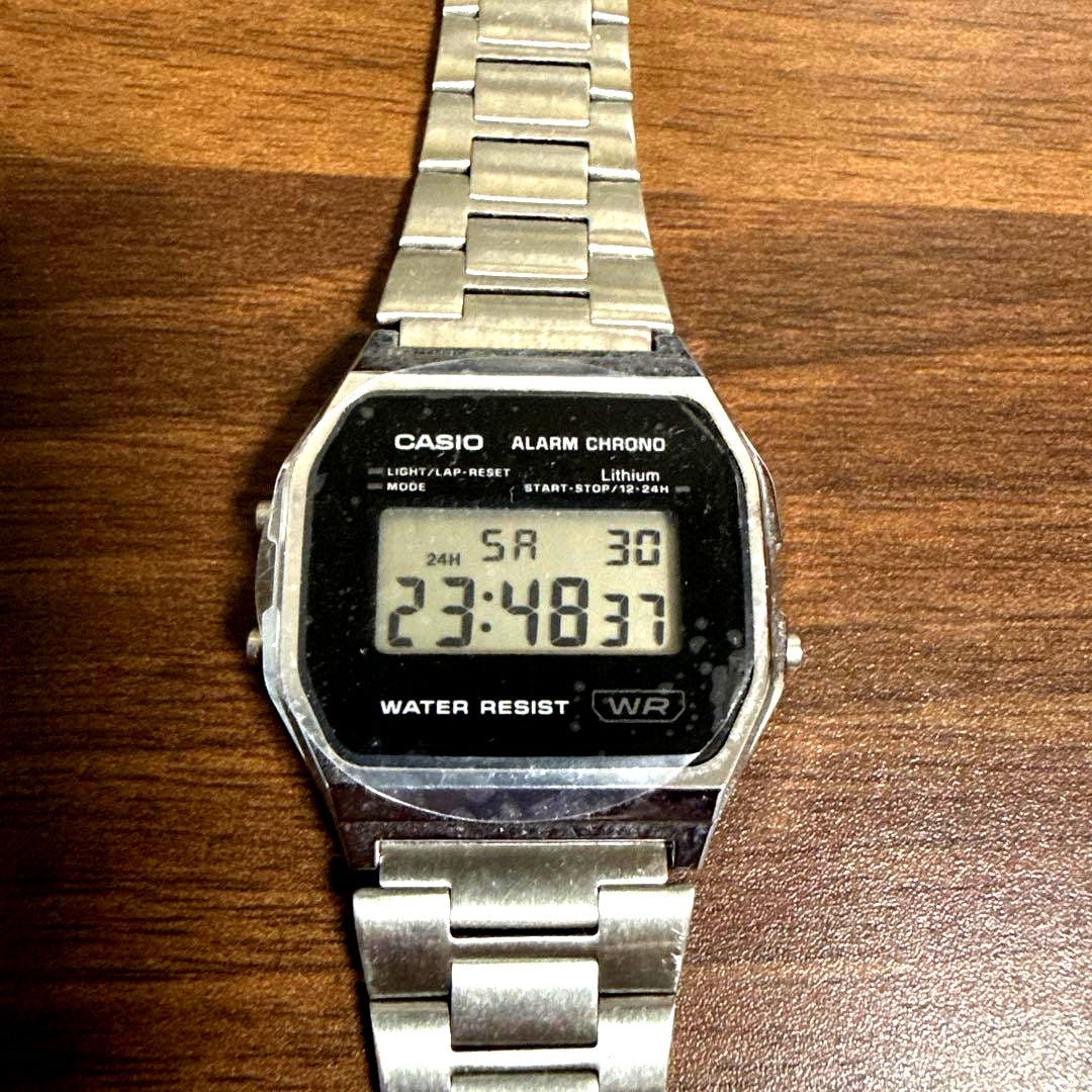 Casio A158WEA-1JF digital watch with black resin band and stainless steel case showing time display