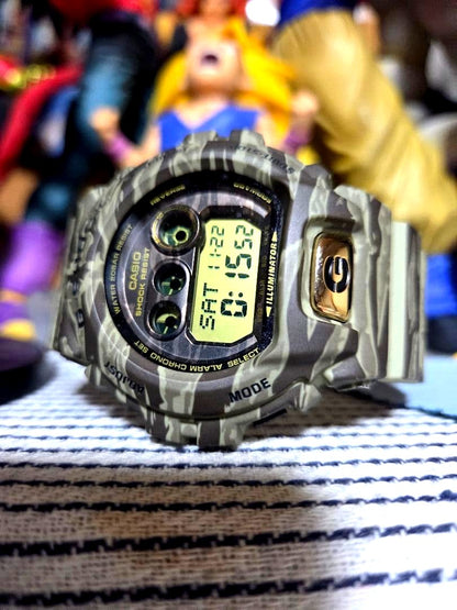 Casio G-Shock digital wristwatch with camouflage rubber band and luminescent digital display