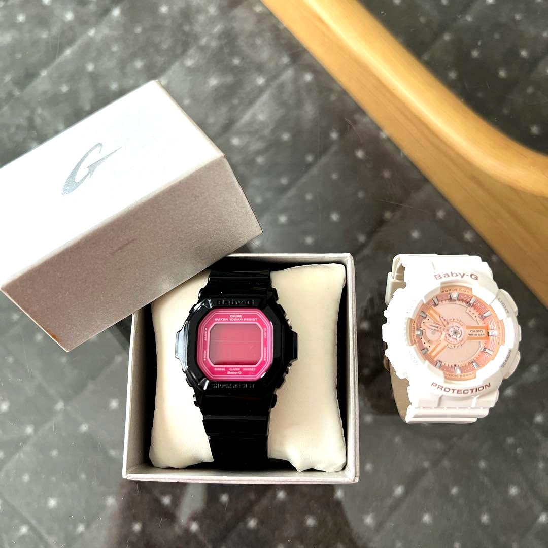 Two used Casio Baby-G BA-110 digital watches with dead batteries displayed side by side