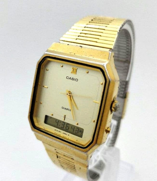 Casio AQ-525 watch with digital and analog display and gold square metal band