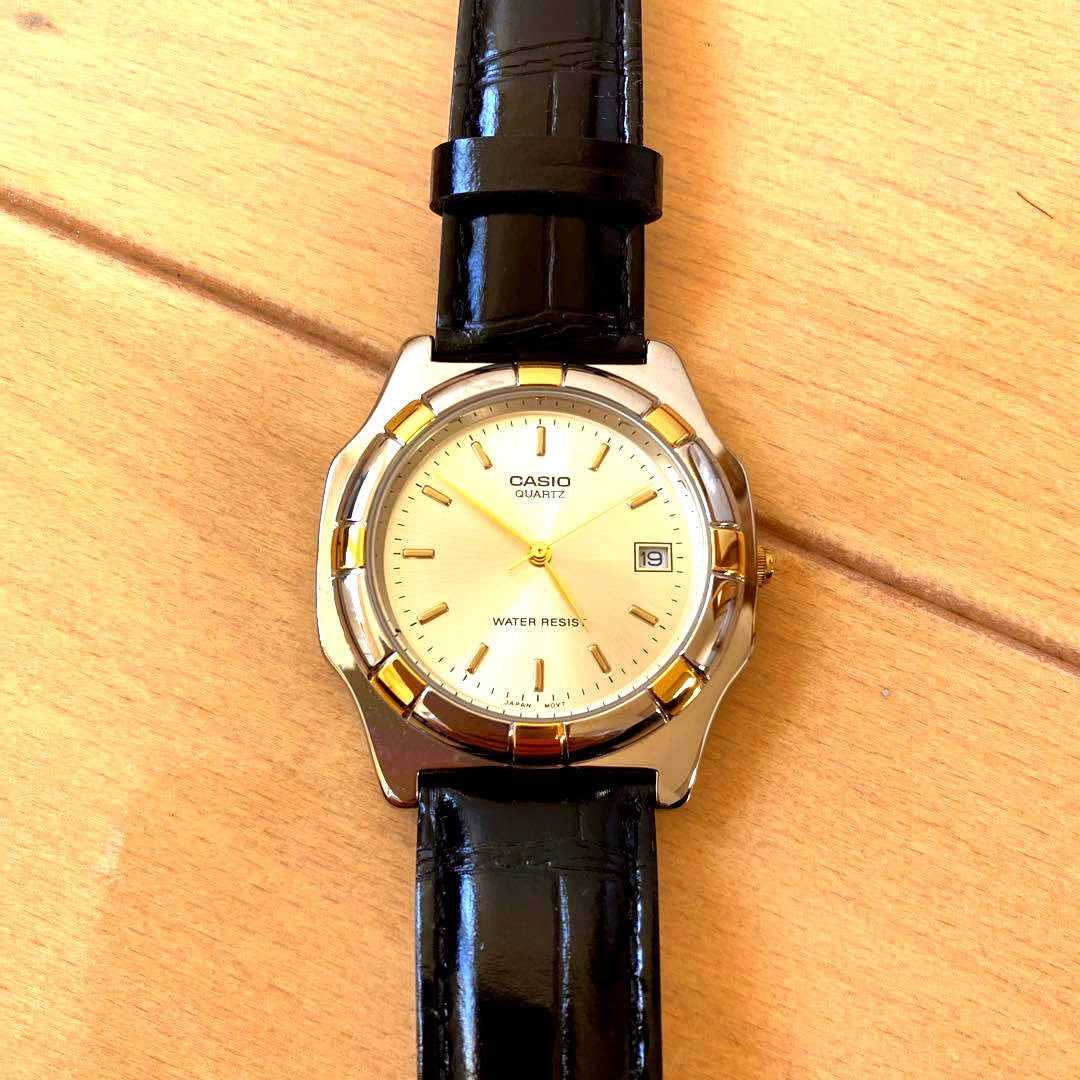 Casio Analog Quartz Watch with gold dial, black accents, and black leather band