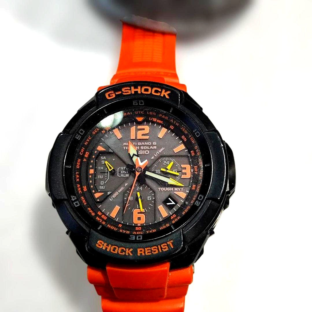 Casio G-Shock GW-3000 Sky Cockpit digital watch with orange replacement band showing scratches and cracks