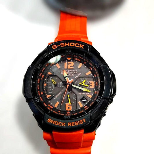 Casio G-Shock GW-3000 Sky Cockpit digital watch with orange replacement band showing scratches and cracks