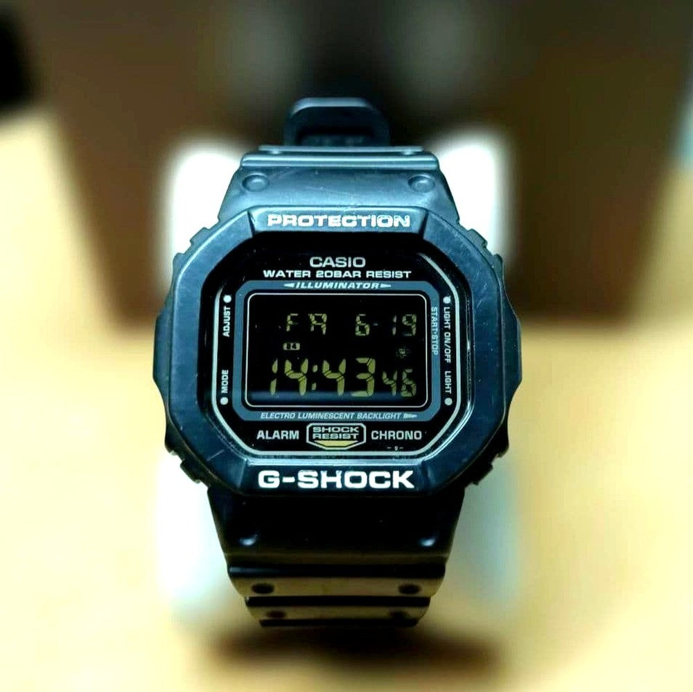 Casio G-Shock DW-5600P Speed Model watch with black case and reversed LCD gold text