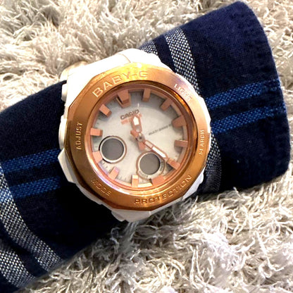 Casio Baby-G digital watch in white and gold with resin band, showing digital display and sleek design