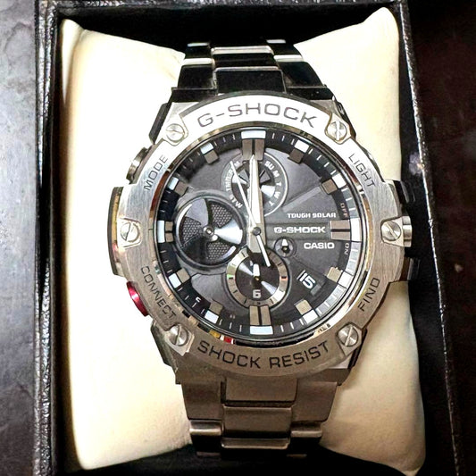 Casio G-Shock GST-B100 silver wristwatch showing the front dial with metallic band
