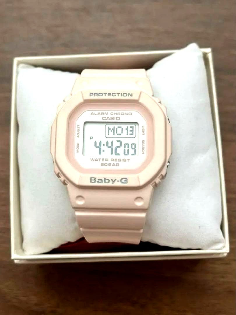 Casio Baby-G pink wristwatch with original box, instruction manual, and cleaning cloth