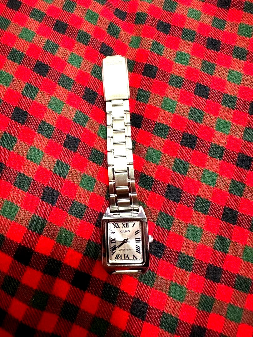 Casio LTP-V007D silver ladies watch with silver dial and adjustable metal band showing minor scratch