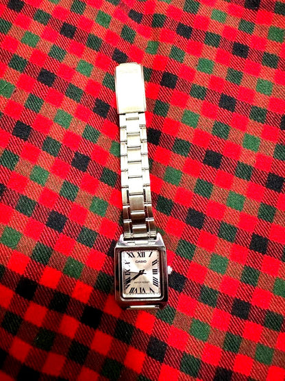 Casio LTP-V007D silver ladies watch with silver dial and adjustable metal band showing minor scratch