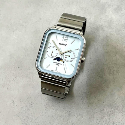 Casio MTP-M305 watch with light blue dial and moon phase display at 6 o'clock position