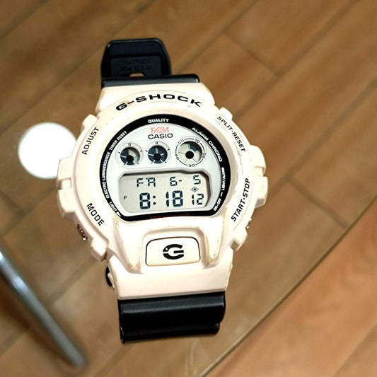 Casio G-Shock DW-6900DQM collaboration model digital wristwatch showing front display with EL backlight