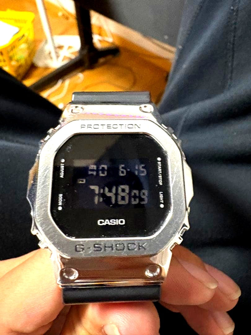 Casio G-Shock GM-5600 digital watch with stainless steel bezel and black resin strap