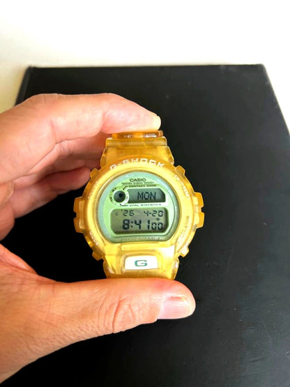 Casio G-Shock DW-6910K Clear Yellow vintage digital watch with calendar, alarm, and backlight features