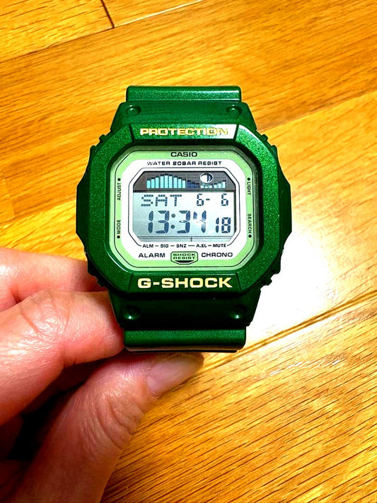 Casio G-Shock GLX-5600A green watch showing used condition with visible scratches and dirt, body only