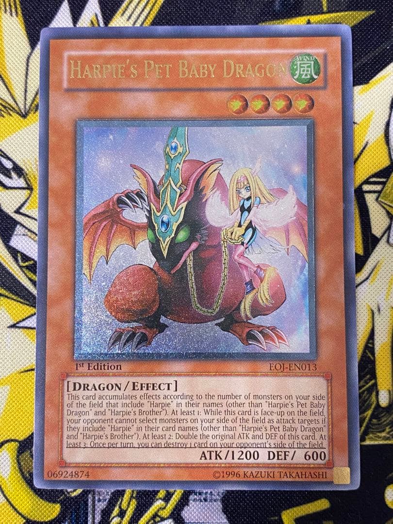 Yu-Gi-Oh Harpies Pet Baby Dragon Relief 1st Edition card showing front with slight dent and scratch on back