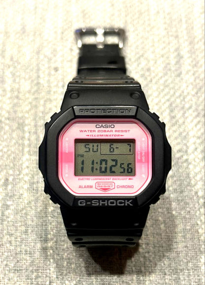 Casio G-Shock DW-5600TCB-1JR Sakura Storm digital watch with black and pink design and alarm feature