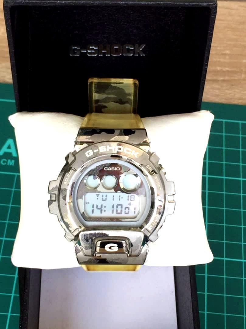 Casio G-Shock GM-6900SCM watch with camouflage metallic skull design, front view