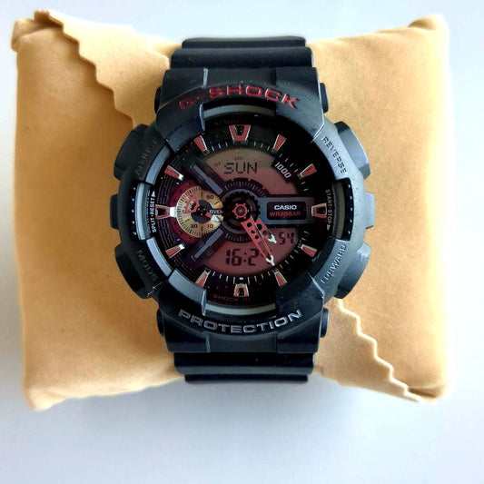 Casio G-Shock GA-110 model watch with black case and digital analog display showing minor wear