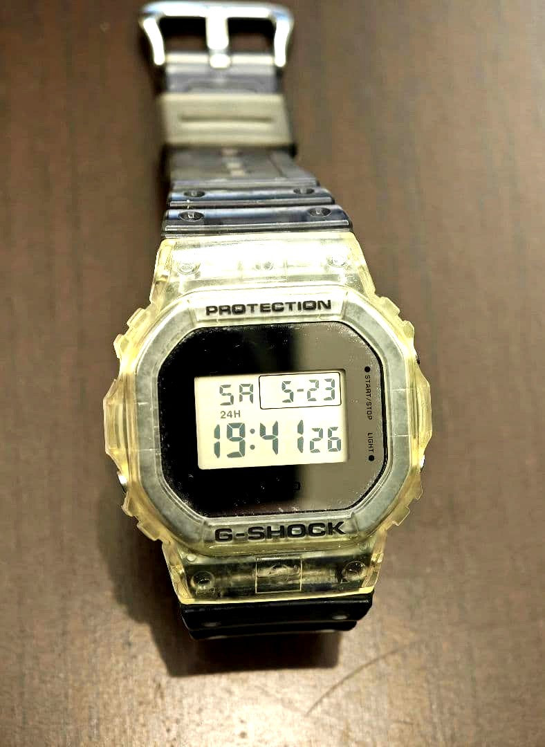 Casio G-Shock DW-5600SK-1 digital watch with clear bezel and black band showing square face