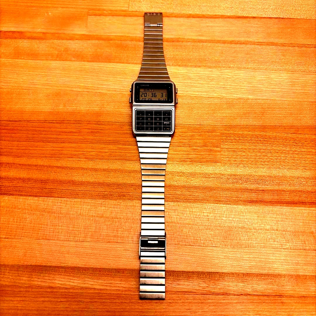 Casio Data Bank DBC-611 silver digital watch featuring a calculator and digital display
