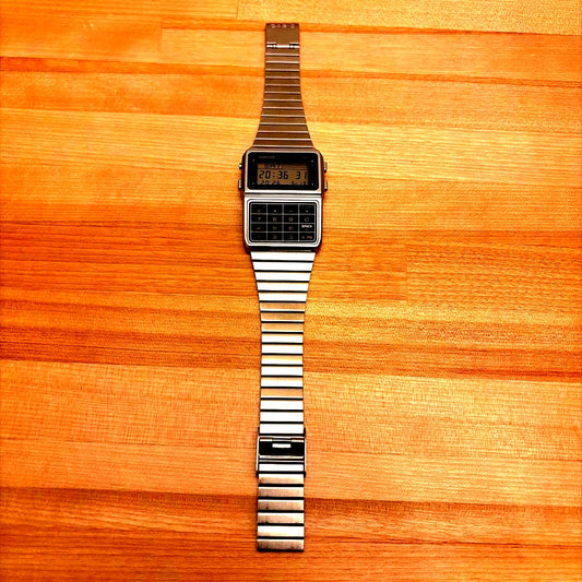 Casio Data Bank DBC-611 silver digital watch featuring a calculator and digital display