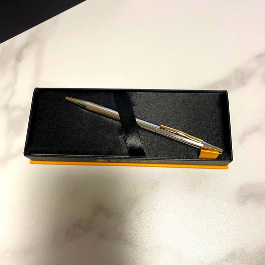 Cross ballpoint pen with silver and gold design displayed with its premium dedicated case