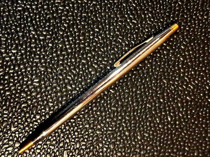 Cross ballpoint pen with silver and gold body, dark blue ink, made in USA, showing signs of use