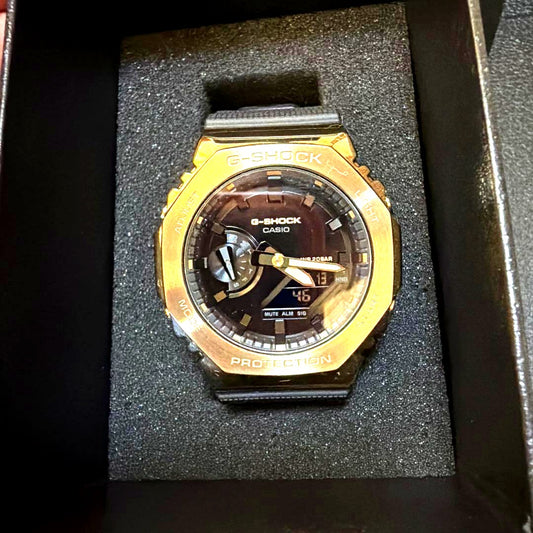 Casio G-Shock GM-2100G digital analog combination watch gold metal bezel black resin band
