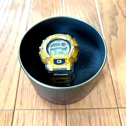 Casio G-Shock X-treme Model X yellow watch with original case showing minor surface scratches