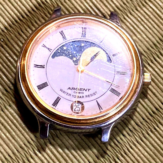 Casio Moon Phase MTW-112M vintage wristwatch showing moon phase dial, no band, minor scratches on stainless steel case