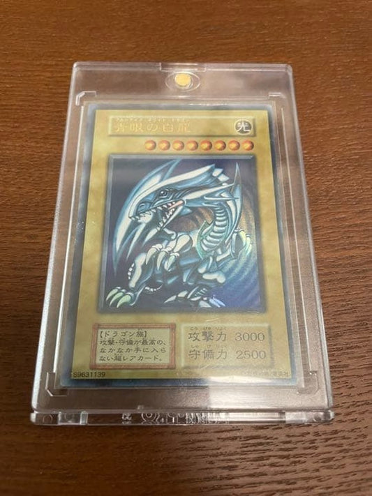 Yu-Gi-Oh Blue-Eyes White Dragon Initial Ultra Rare trading card with minor surface scratches