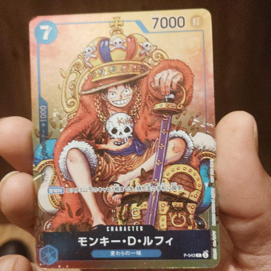 One Piece Monkey D. Luffy character card P-043 wearing a crown with power 7000 and strike attribute