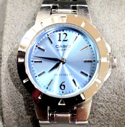 Casio quartz wristwatch with light blue analog dial and silver stainless steel band approximately 6.9 inches long