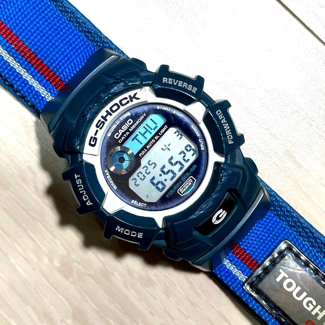 Casio G-Shock Tough Solar Data Memory Watch with white and blue body showing usage wear