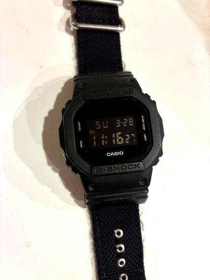 Casio G-Shock DW-5600BBN-1 black digital watch with nylon strap, Japan import, front view