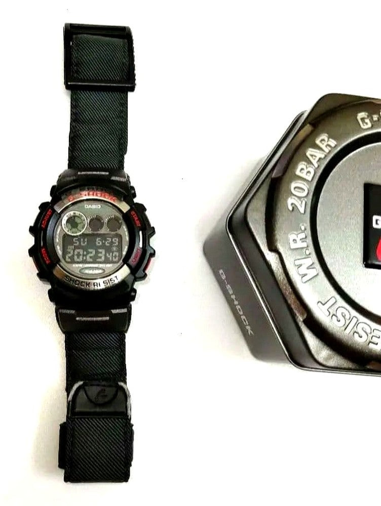 Casio G-Shock G-Lide GL-110V-3JF watch with green nylon band and digital display showing backlight feature