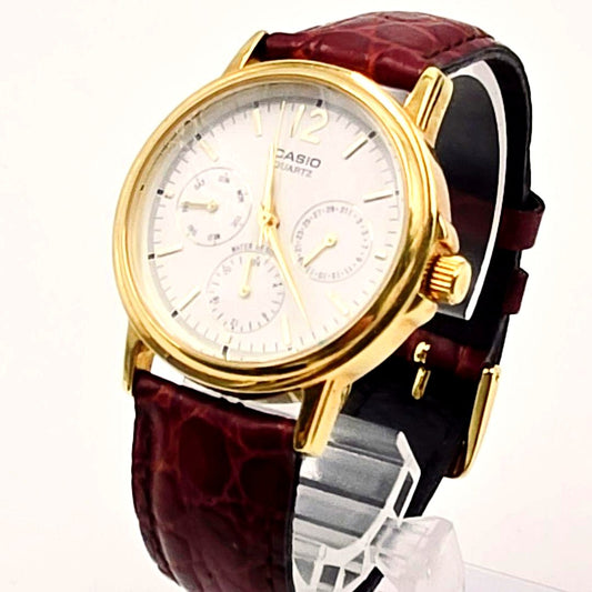 Casio MTP-1174 men's quartz watch with white dial and brown leather strap showing date display