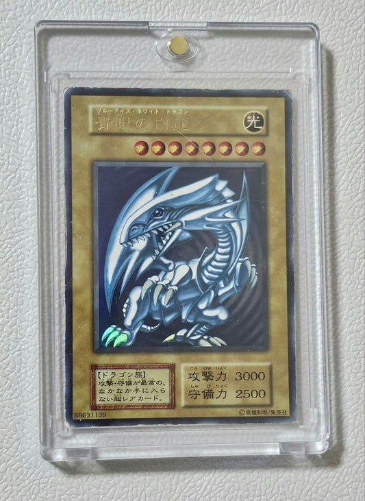 Yugioh Blue-Eyes White Dragon Ultra Rare card from 1999 Starter Box showing scratches and edge wear