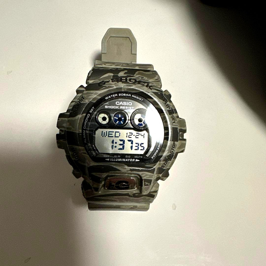 Casio G-Shock digital watch with camouflage pattern and digital display, backlight, and durable design