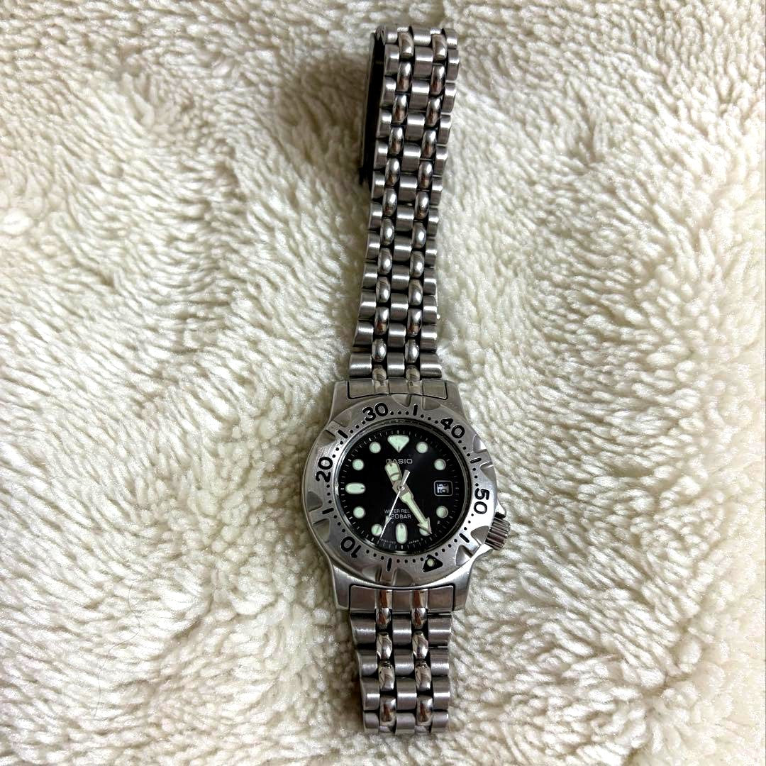 Vintage Casio wristwatch showing scratches and signs of wear on the face and band