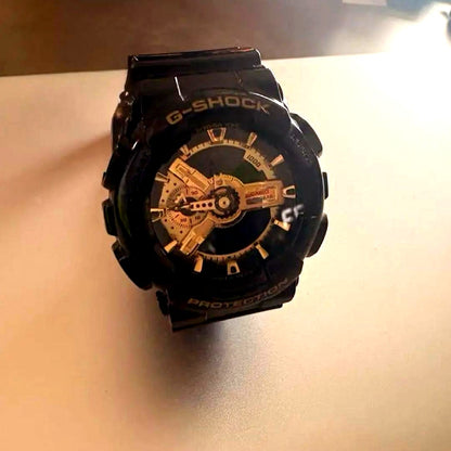 Casio G-Shock GA-110GB black and gold wristwatch Japan import showing front view