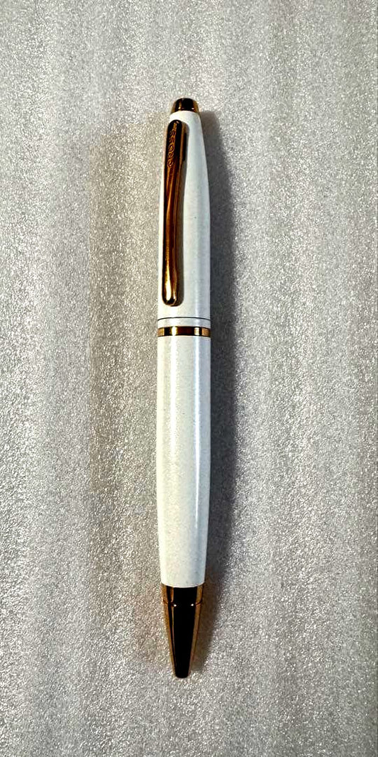 Cross pen with white body and gold trim, thick barrel design, used condition with noticeable wear