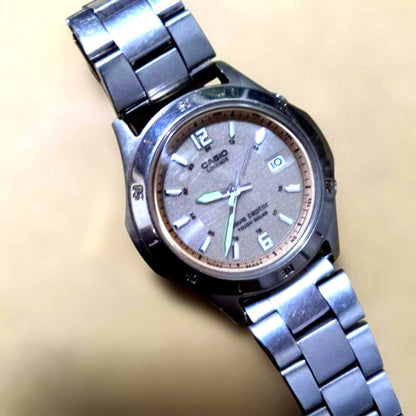 Casio silver analogue radio wave solar watch with date display and stainless steel band